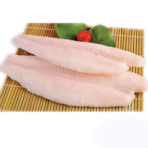 Two raw fish fillets placed on a bamboo mat with green leaves and a cherry tomato garnish