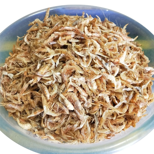 driend small shrips Bowl filled with small dried shrimp, showing their light brown color and curled shapes